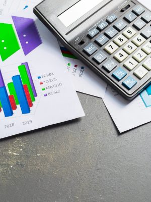 Checking accounting report on business table. Calculator